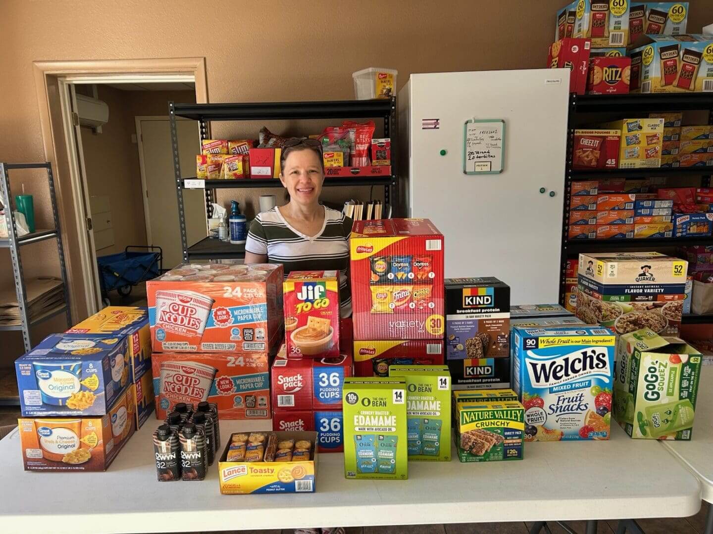 Smiling woman arranging boxed snacks on table
